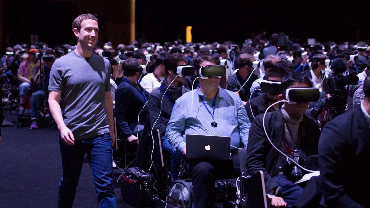Mark Zuckerberg in a grey t-shirt strolling past hundreds of seated attendees at Mobile World Congress 2016, all of them wearing Samsung Gear VR headsets and oblivious to his presence.